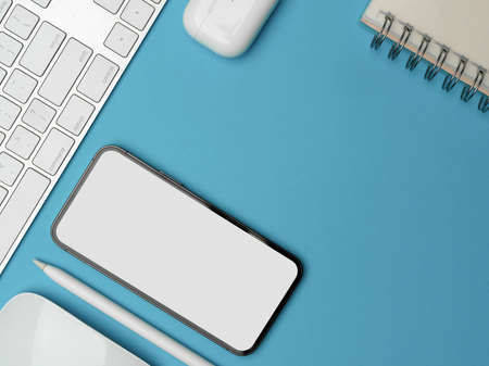 Top view, creative flat lay workspace with smartphone, computer accessories and copy space on light...