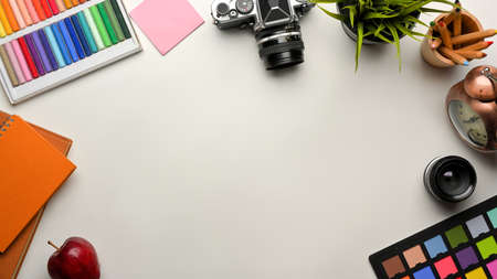 Creative mock up scene, designer workspace with paint tools, camera, stationery and copy space, top viewの写真素材