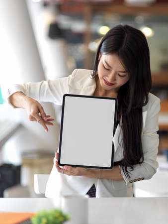 Cropped shot of businesswoman presenting mock up digital tablet include clipping path screenの写真素材