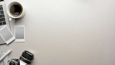 Mock up scene creative flat lay in travel concept with travel items, camera, photo frame, laptop, coffee cup and copy space on white backgroundの写真素材