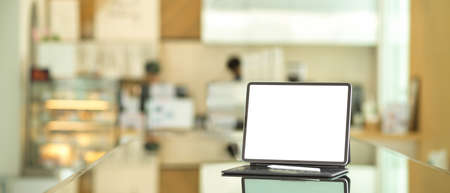 Close up view of mock up digital tablet include clipping path screen on the table in coffee shopの写真素材