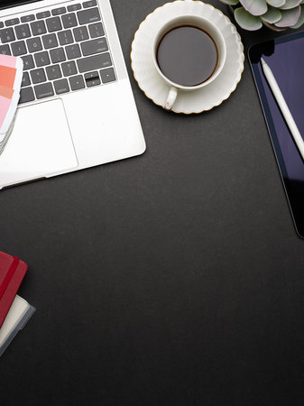 Creative flat lay workspace with laptop, notebooks, coffee cup, supplies and copy space, top viewの写真素材