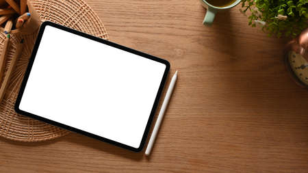 Top view of creative flat lay wooden workspace with digital tablet include clipping path and decorationsの写真素材