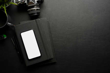 Creative flat lay workspace with smartphone, camera, stationery and copy space, clipping path, top viewの写真素材