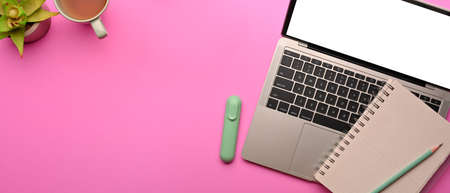 Top view of pink creative flat lay workspace with laptop, stationery and copy space, clipping pathの写真素材