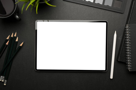 Top view of creative flat lay workspace with digital tablet include clipping path and supplies on black tableの写真素材