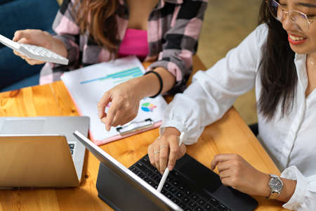 Top view of two female students having funny conversation and brainstorming while doing group...