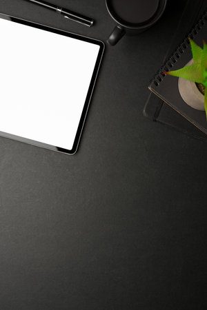 Creative flat lay workspace with digital tablet, supplies and copy space on black table, clipping pathの写真素材