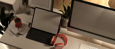 3D rendering, computer desk with digital tablet, headphone, equipments and decorations in home office room, 3D Illustration, cropped shotの写真素材