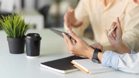 Cropped shot of young business people discussing the project together in the office roomの写真素材