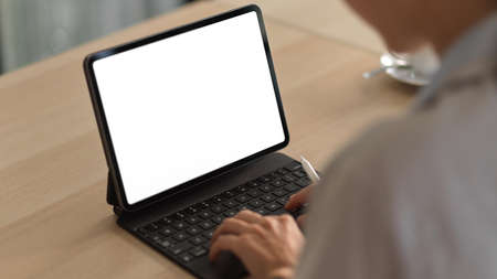 Cropped shot of young female working with mock up digital tablet in office room, include clipping pathの写真素材