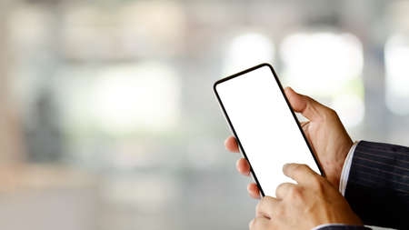 Close up view of businessman hands using smartphone include clipping path screen in blurred backgroundの写真素材