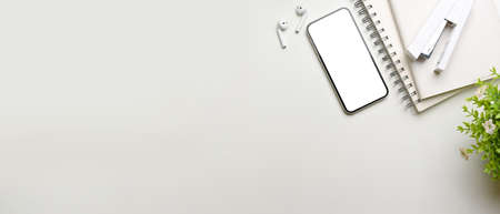 Creative flat lay workspace with smartphone, stationery, accessories and copy pace, top view, clipping pathの写真素材