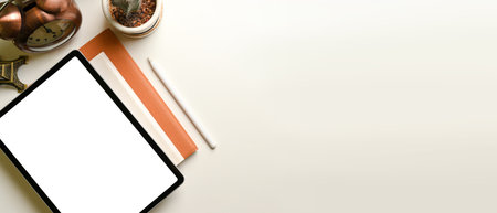 Top view of simple study table with digital tablet, stationery, decorations and copy space on white desk, clipping pathの写真素材