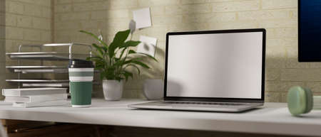 Comfortable workspace with laptop, plant pot and supplies on the table, 3D renderingの写真素材