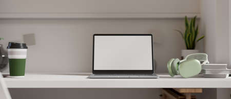 3D rendering, portable workspace with laptop, headphone, books, tumbler and decorations in minimal room, 3D illustrationの写真素材