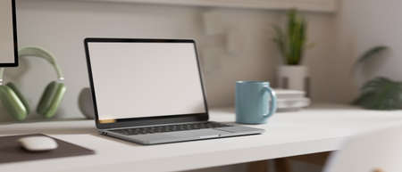 3D rendering, simple workspace with laptop, mug, headphone and plant pot on the table, 3D illustrationの写真素材