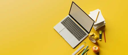 Top view, 3D rendering, stylish workspace with laptop, stationery, school elements and copy space on yellow background, 3D illustrationの写真素材