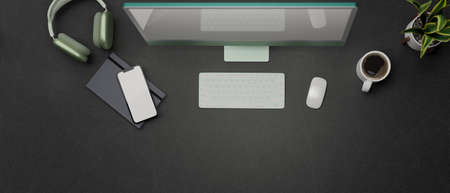 3D rendering, dark workspace with computer device, smartphone, notebook, headphone and copy space, top view, 3D illustrationの写真素材