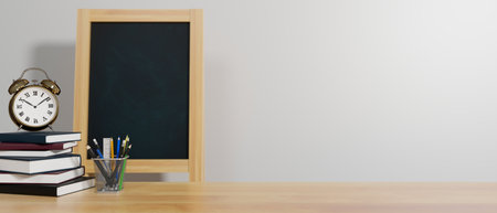 Education concept, 3D rendering, school elements on the table with books, stationery, alarm clock, chalk board, and copy space, 3D illustrationの写真素材