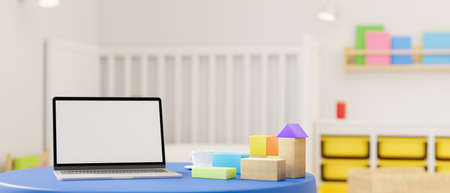 3D rendering, laptop with mock-up screen on round table with playthings in kid bedroom with bed and shelf on the back, 3D illustrationの写真素材