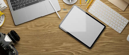 3D rendering, digital tablet with mock-up screen, laptop, camera and accessories on wooden table, 3D illustrationの写真素材