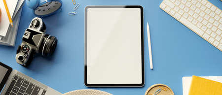 3D rendering, digital tablet with mock-up screen, camera, laptop and accessories on blue background,...