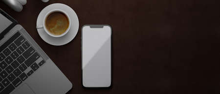 3D rendering, smartphone with mock-up screen on brown leather background with laptop and coffee cup, 3D illustration, top viewの写真素材