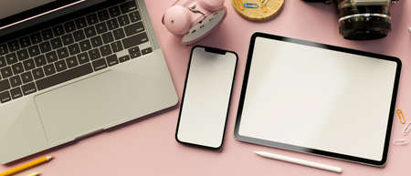 3D rendering, digital tablet and smartphone with mock-up screen on pink pastel background with laptop and supplies, 3D illustrationの写真素材