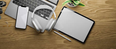 3D rendering, flat lay of workspace with digital tablet, smartphone, laptop, headphone and plant pot on wooden table, 3D illustrationの写真素材