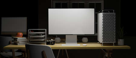 3D rendering, computer device with mock-up screen on wooden table with  office supplies and chair in home office at night, 3D illustrationの写真素材
