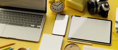 3D rendering, flat lay of workspace with laptop, digital tablet, smartphone with mock-up screen, camera and stationery, 3D illustrationの写真素材