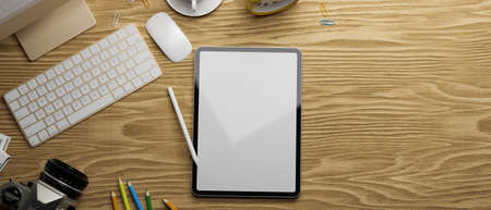 3D rendering, digital tablet with mock-up screen, camera and computer accessories on wooden table, 3D illustrationの写真素材