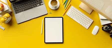 3D rendering, digital tablet with mock-up screen on yellow background with laptop and computer devices, 3D illustrationの写真素材