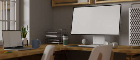 3D rendering, computer and laptop with mock-up screen and office supplies on wooden table in simple office workspace, 3D illustrationの写真素材