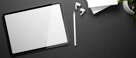 3D rendering, digital tablet with mock-up screen, accessories and books on black table, 3D illustrationの写真素材