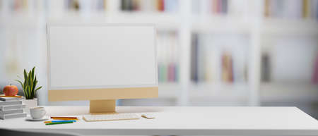 Computer with mock-up screen on white table with stationery and plant pot in study room, 3D illustration, 3D renderingの写真素材
