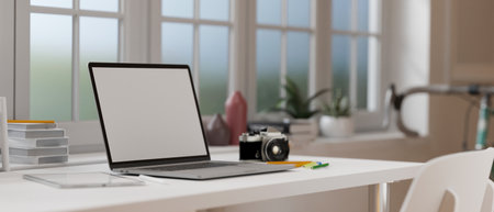 3D rendering, laptop with mock-up screen on white desk with camera, books and supplies in home office room, 3D illustrationの写真素材