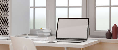 Mock-up laptop on white table beside the window in white concept office room, 3D rendering, 3D illustrationの写真素材
