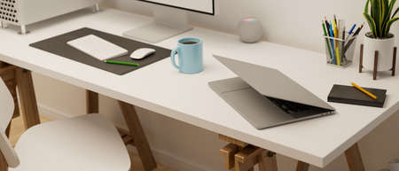 Computer table with laptop and stationery in office room, 3D rendering, 3D illustrationの写真素材