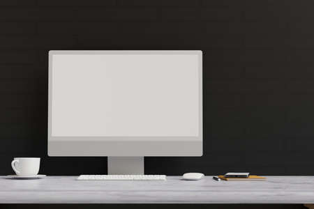 Computer monitor with mock-up screen on marble desk with stationery in black wall background, 3D rendering, 3D illustrationの写真素材
