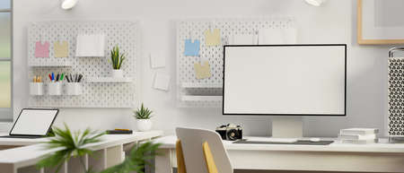 Computer with mock-up screen on the working table in white concept office room, 3D rendering, 3D illustrationの写真素材