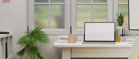 Laptop with mock-up screen on computer table beside the window in home office room, 3D rendering, 3D illustrationの写真素材