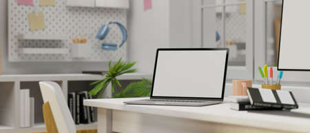 Laptop with mock-up screen on computer table in minimal home office room, 3D rendering, 3D illustrationの写真素材