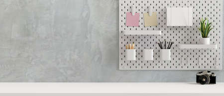 Simple workspace with stationery and plant pot on the shelves decorated on the wall and camera on the table, 3D rendering, 3D illustrationの写真素材