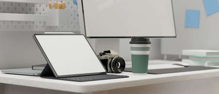 Side view of digital tablet with mock-up screen on computer table in modern working space, 3D rendering, 3D illustrationの写真素材