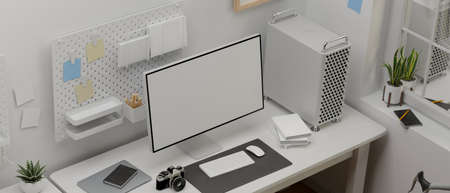 Top view of computer device with mock-up screen on white table in comfortable office room, 3D...