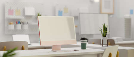 Pink pastel computer monitor on white desk in modern office room, 3D rendering, 3D illustrationの写真素材