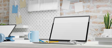 Laptop with mock-up screen, office supplies and plant pot on the table, 3D rendering, 3D illustrationの写真素材