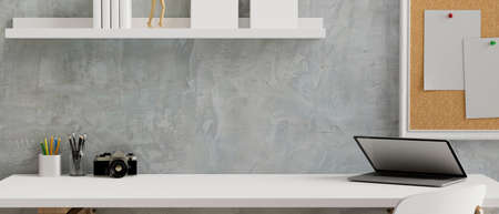 Working space with laptop, camera and stationery on the table, notice board and books shelf on loft wall, 3D rendering, 3D illustrationの写真素材